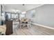 Bright dining room with wood table and chandelier, open to kitchen at 18015 Fenders Way, Land O Lakes, FL 34638