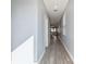 Long hallway with tile floor offering views into living area at 18015 Fenders Way, Land O Lakes, FL 34638