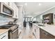 Modern kitchen with stainless steel appliances and white cabinetry at 18015 Fenders Way, Land O Lakes, FL 34638
