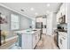 Open concept kitchen boasts white cabinets and stainless steel appliances at 18015 Fenders Way, Land O Lakes, FL 34638