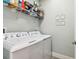 Laundry room with washer, dryer, and additional shelving for storage at 18015 Fenders Way, Land O Lakes, FL 34638