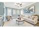Relaxing living room, featuring a comfy couch and armchair at 18015 Fenders Way, Land O Lakes, FL 34638