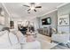 Open living room with sectional sofa and view to dining area at 18015 Fenders Way, Land O Lakes, FL 34638