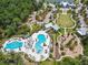 Large community pool with a water slide and adjacent playground at 18015 Fenders Way, Land O Lakes, FL 34638