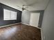 Bedroom with wood-look floors and double closet doors at 18116 Portside St, Tampa, FL 33647