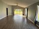 Spacious living room with wood-look floors and large windows at 18116 Portside St, Tampa, FL 33647