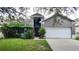 Two story house with a double garage and lush landscaping at 19130 Wood Sage Dr, Tampa, FL 33647