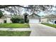 Gray house with white garage door and landscaping at 19130 Wood Sage Dr, Tampa, FL 33647