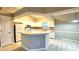 Bright kitchen with white cabinets, tile floors, and a breakfast bar at 19130 Wood Sage Dr, Tampa, FL 33647