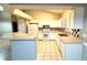 Eat-in kitchen, featuring white cabinets and tile flooring at 19130 Wood Sage Dr, Tampa, FL 33647