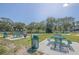 Community picnic area with tables and grills near a lake at 2073 Denmark St # 25, Clearwater, FL 33763