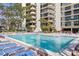 Community pool with lounge chairs at 2413 Bayshore Blvd # 404, Tampa, FL 33629