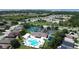 Aerial view of community pool, tennis courts, and homes at 2749 Plantain Dr, Holiday, FL 34691