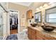 Elegant bathroom with dual sinks, granite countertop, walk-in shower, and large closet at 2749 Plantain Dr, Holiday, FL 34691