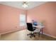 Pink bedroom with a work desk, offering versatility as a home office at 2749 Plantain Dr, Holiday, FL 34691