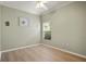 Simple bedroom with light walls, wood-look flooring and a window with blinds at 2749 Plantain Dr, Holiday, FL 34691