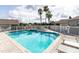 Refreshing community pool with a spa and surrounding patio at 2749 Plantain Dr, Holiday, FL 34691