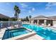 Relaxing community pool and spa with plenty of lounge chairs at 2749 Plantain Dr, Holiday, FL 34691