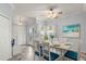 Dining area with white table and blue chairs, light gray walls at 2749 Plantain Dr, Holiday, FL 34691