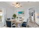 Light-filled dining room with a farmhouse table and blue chairs at 2749 Plantain Dr, Holiday, FL 34691