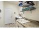 Bright laundry room with washer, dryer, utility sink, and ample storage at 2749 Plantain Dr, Holiday, FL 34691