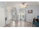 Living room with light gray walls, wood-look floors, and bay window at 2749 Plantain Dr, Holiday, FL 34691