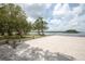 Scenic sandy beach with picnic tables and water access at 2749 Plantain Dr, Holiday, FL 34691
