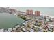 Aerial view of waterfront homes and neighborhood with high rises visible at 306 180Th E Ave, Redington Shores, FL 33708