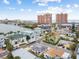 Aerial view of waterfront homes and neighborhood with city skyline in background at 306 180Th E Ave, Redington Shores, FL 33708