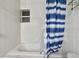 Small bathroom with tub and shower curtain at 306 180Th E Ave, Redington Shores, FL 33708