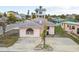 Pink single story home with gray roof, landscaping, and a small yard at 306 180Th E Ave, Redington Shores, FL 33708