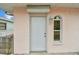 White front door and side window on a pink house at 306 180Th E Ave, Redington Shores, FL 33708