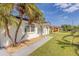 Single story home with walkway, palm trees and well-manicured lawn at 3309 Jackson Dr, Holiday, FL 34691