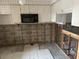 Kitchen undergoing renovation, featuring new cabinets and flooring at 4366 Summersun Dr, New Port Richey, FL 34652