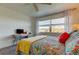 Bedroom with queen bed, yellow throw, and desk area at 4455 Duhme Rd # 304, St Petersburg, FL 33708