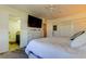 Bedroom with large TV, dresser, and ensuite bathroom at 4455 Duhme Rd # 304, St Petersburg, FL 33708