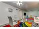 Dining area with glass table, white chairs, and living room view at 4455 Duhme Rd # 304, St Petersburg, FL 33708