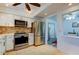 Modern kitchen with stainless steel appliances and breakfast bar at 4455 Duhme Rd # 304, St Petersburg, FL 33708