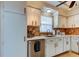 Updated kitchen with white cabinets and tile backsplash at 4455 Duhme Rd # 304, St Petersburg, FL 33708