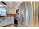 Stainless steel appliances and white cabinets in kitchen at 4455 Duhme Rd # 304, St Petersburg, FL 33708
