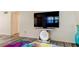 Living room with large TV, colorful rug, and modern decor at 4455 Duhme Rd # 304, St Petersburg, FL 33708
