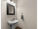 Small bathroom with pedestal sink, and updated mirror at 5041 Sunridge Palms Dr # 103, Tampa, FL 33617