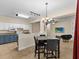 Dining area with a gray table, and four chairs, and a chandelier at 5041 Sunridge Palms Dr # 103, Tampa, FL 33617