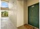 Apartment building entry with green door and welcome mat at 5041 Sunridge Palms Dr # 103, Tampa, FL 33617