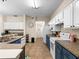 Modern kitchen with white and blue cabinets and tile floors at 5041 Sunridge Palms Dr # 103, Tampa, FL 33617