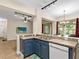 Updated kitchen featuring a breakfast bar and a view into the living area at 5041 Sunridge Palms Dr # 103, Tampa, FL 33617