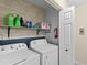 Laundry room with washer, dryer, and shelving at 5041 Sunridge Palms Dr # 103, Tampa, FL 33617