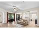 Open living room features tile floors, a comfy couch, and access to the patio at 5041 Sunridge Palms Dr # 103, Tampa, FL 33617