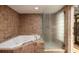 Bathroom featuring a corner jacuzzi tub and a glass shower at 531 Garrard Dr, Temple Terrace, FL 33617