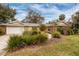 House exterior features a two-car garage and nicely landscaped lawn at 531 Garrard Dr, Temple Terrace, FL 33617